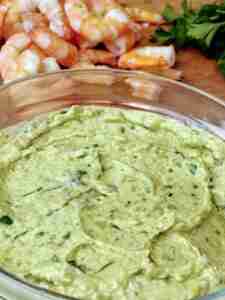 A bowl of gucamole cream with shrimp