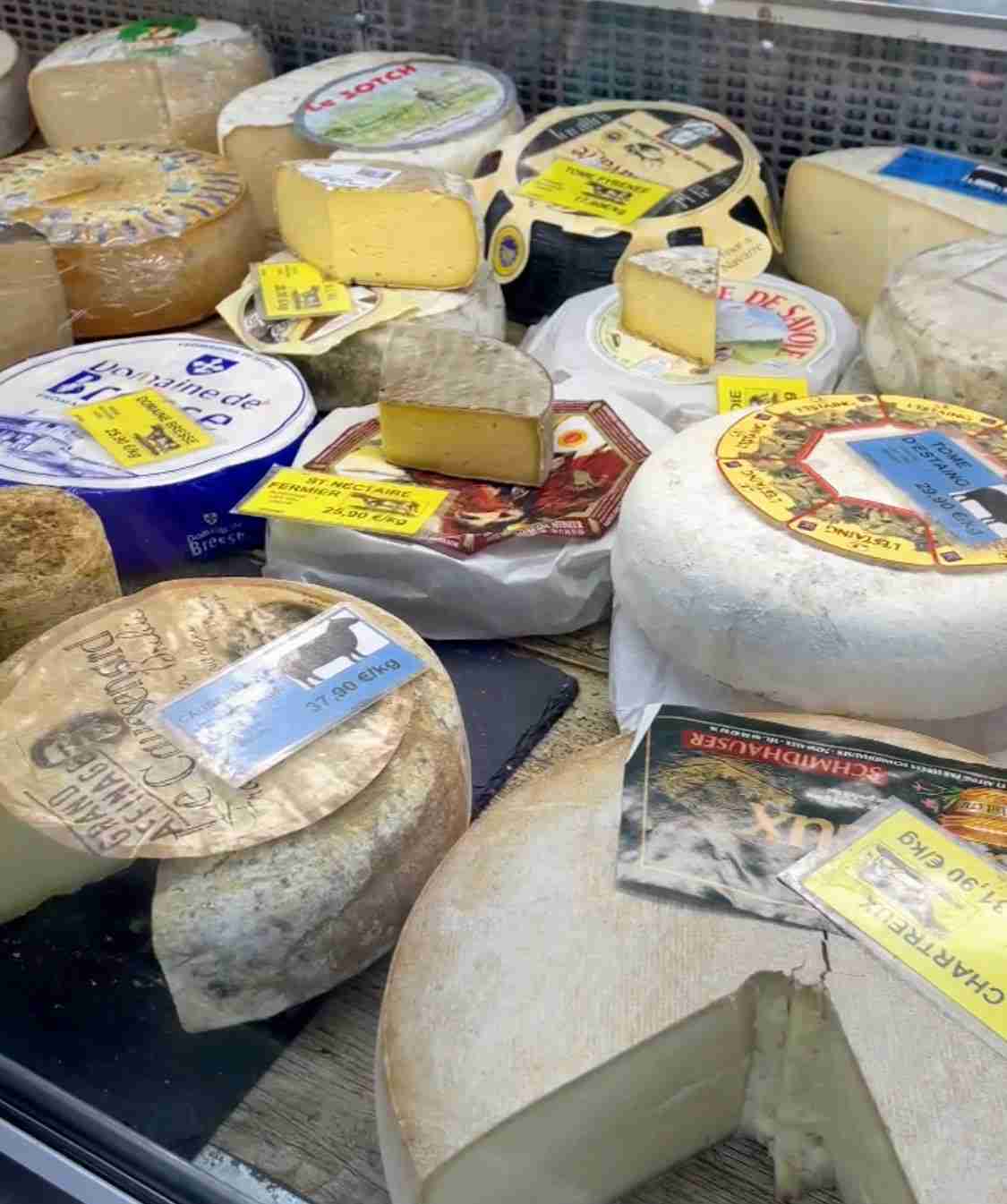 an assortment of cheese at a market in France